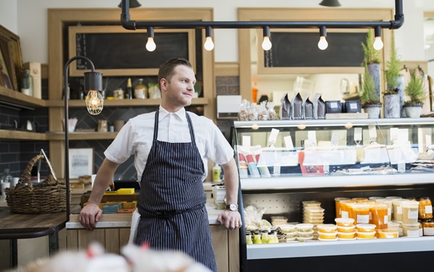 A bakery owner waiting for customers in his shop.