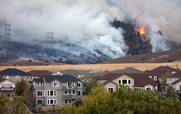 Fireman fights a wildfire.